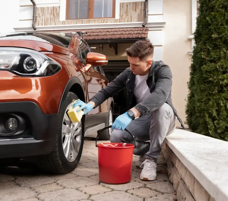 Lavage auto à domicile Douchy-les-Mines : professionnel intervenant sur un véhicule